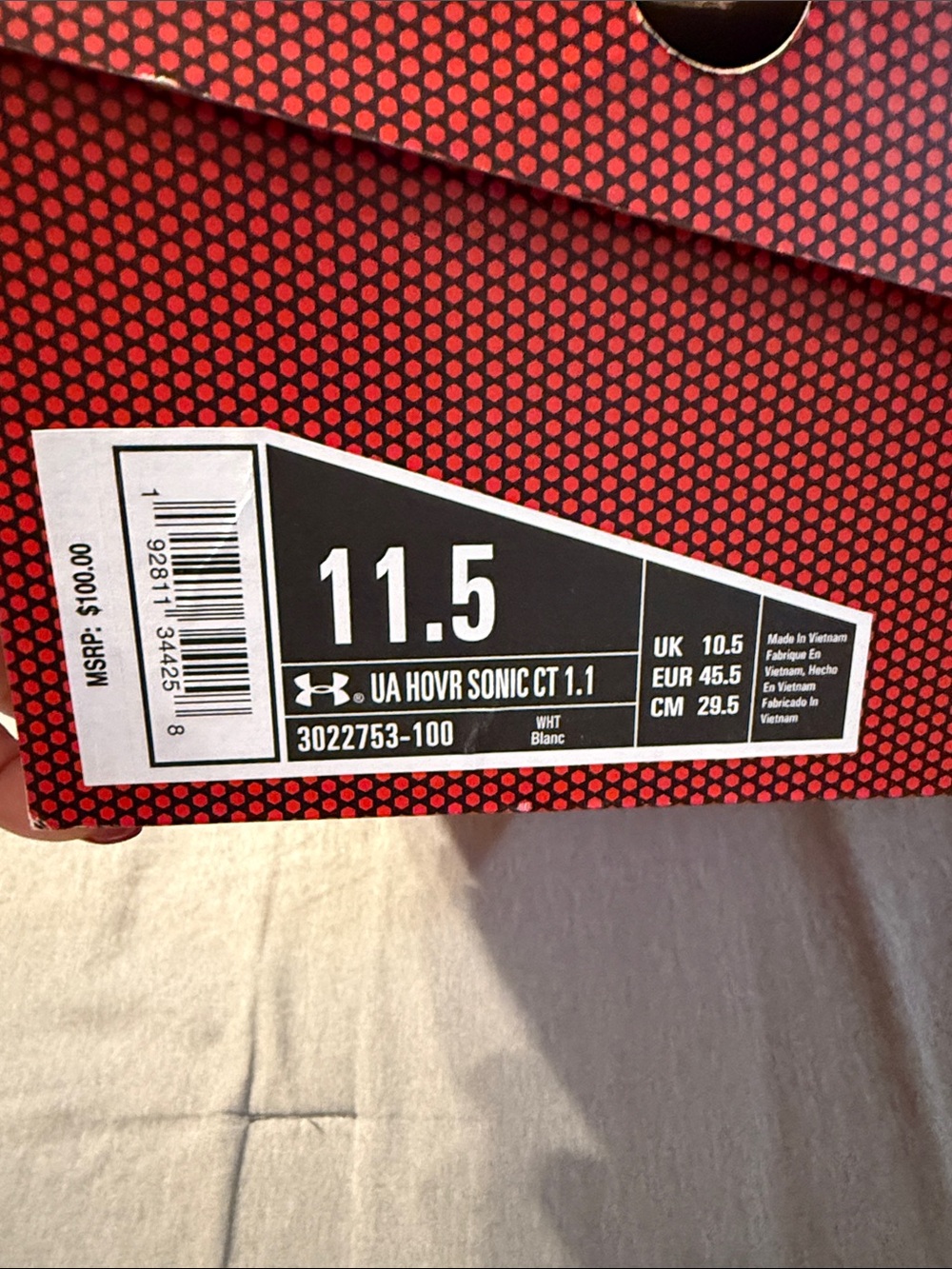 Under Armour box label in black and white with red patterned background